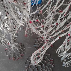 Close-up detail, Reciprocal Space, beverage cartons, tape, gesso, 280 x 180 x 90 cm.