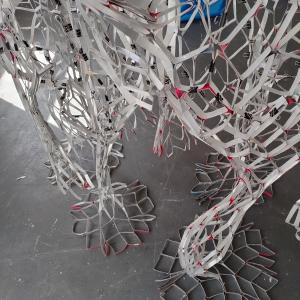 Close-up detail, Reciprocal Space, beverage cartons, tape, gesso, 280 x 180 x 90 cm.